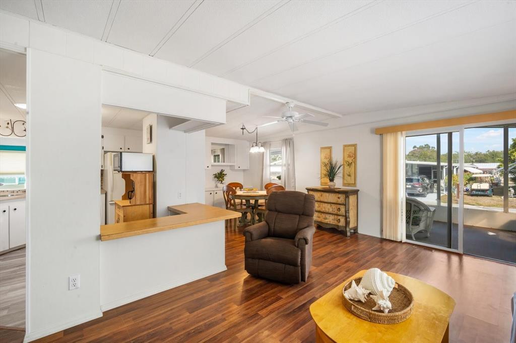 5619 Bayshore Road, Unit 417 Palmetto, FL 34221 - Photo 12 of 36 a living room with furniture and a wooden floor