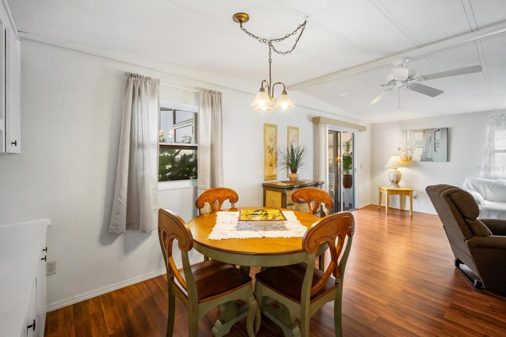 5619 Bayshore Road, Unit 417 Palmetto, FL 34221 - Photo 13 of 36 a view of a dining room with furniture window and wooden floor