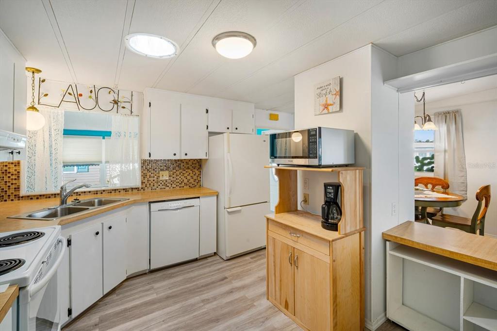 5619 Bayshore Road, Unit 417 Palmetto, FL 34221 - Photo 14 of 36 a kitchen with a sink stove and refrigerator