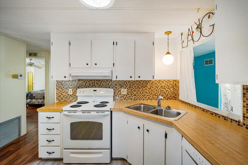 5619 Bayshore Road, Unit 417 Palmetto, FL 34221 - Photo 15 of 36 a kitchen with granite countertop a sink a stove and cabinets