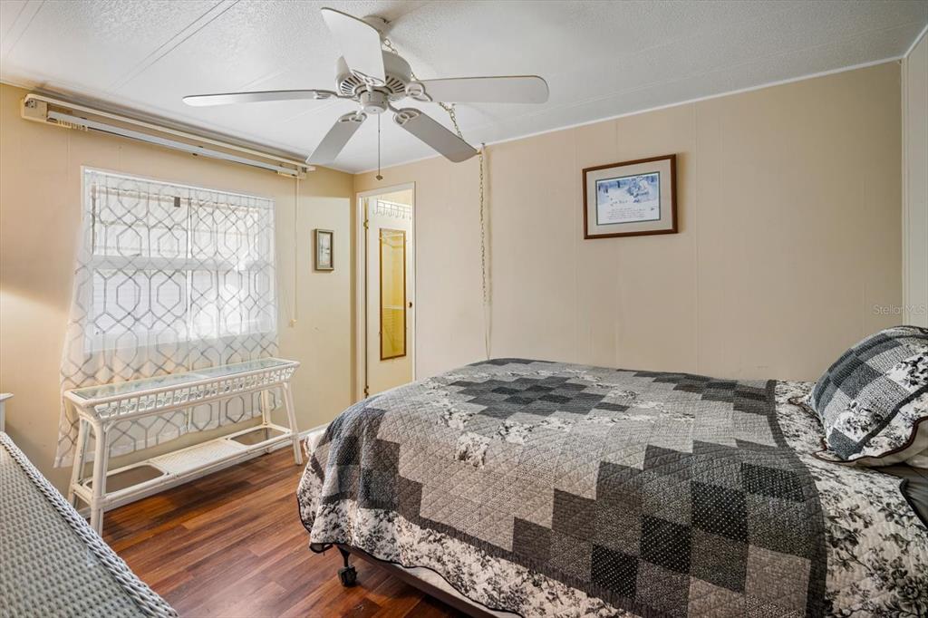 5619 Bayshore Road, Unit 417 Palmetto, FL 34221 - Photo 17 of 36 a bedroom with a bed and a chandelier