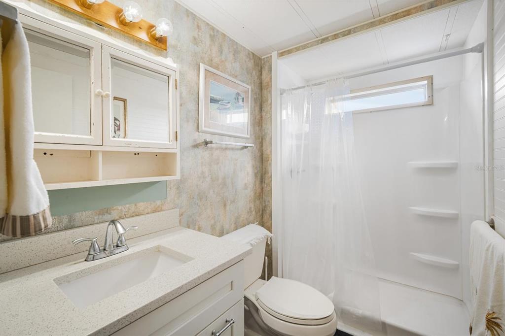 5619 Bayshore Road, Unit 417 Palmetto, FL 34221 - Photo 19 of 36 a bathroom with a sink a toilet and shower