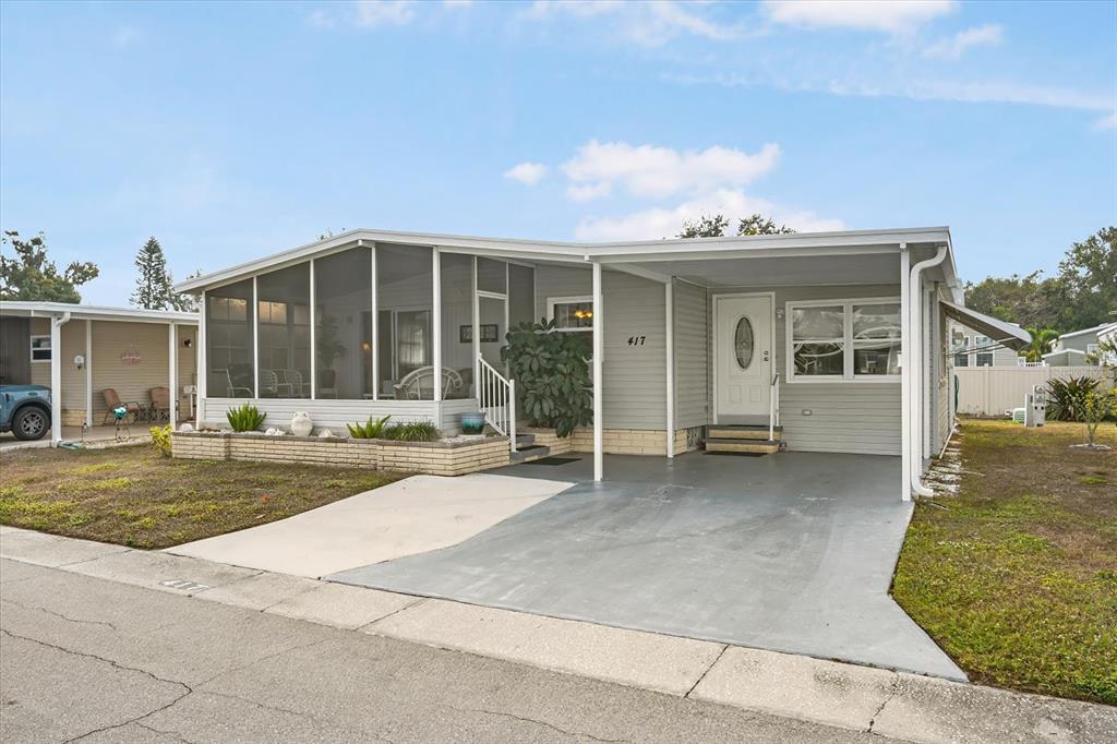 5619 Bayshore Road, Unit 417 Palmetto, FL 34221 - Photo 3 of 36 front view of a house with a porch