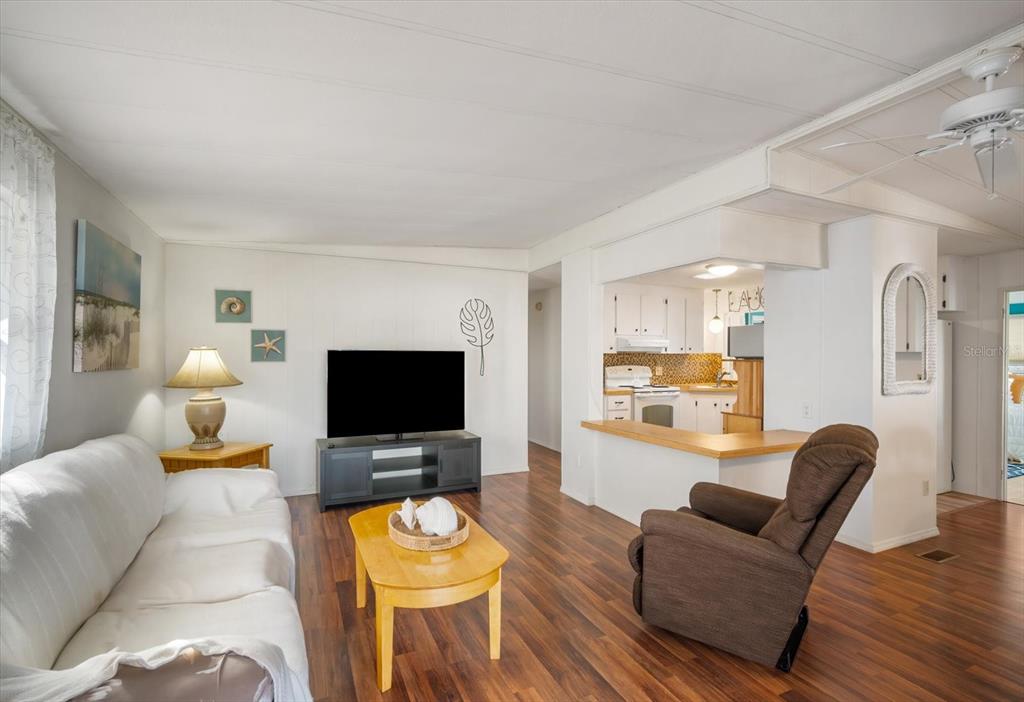 5619 Bayshore Road, Unit 417 Palmetto, FL 34221 - Photo 10 of 36 a living room with furniture and a flat screen tv