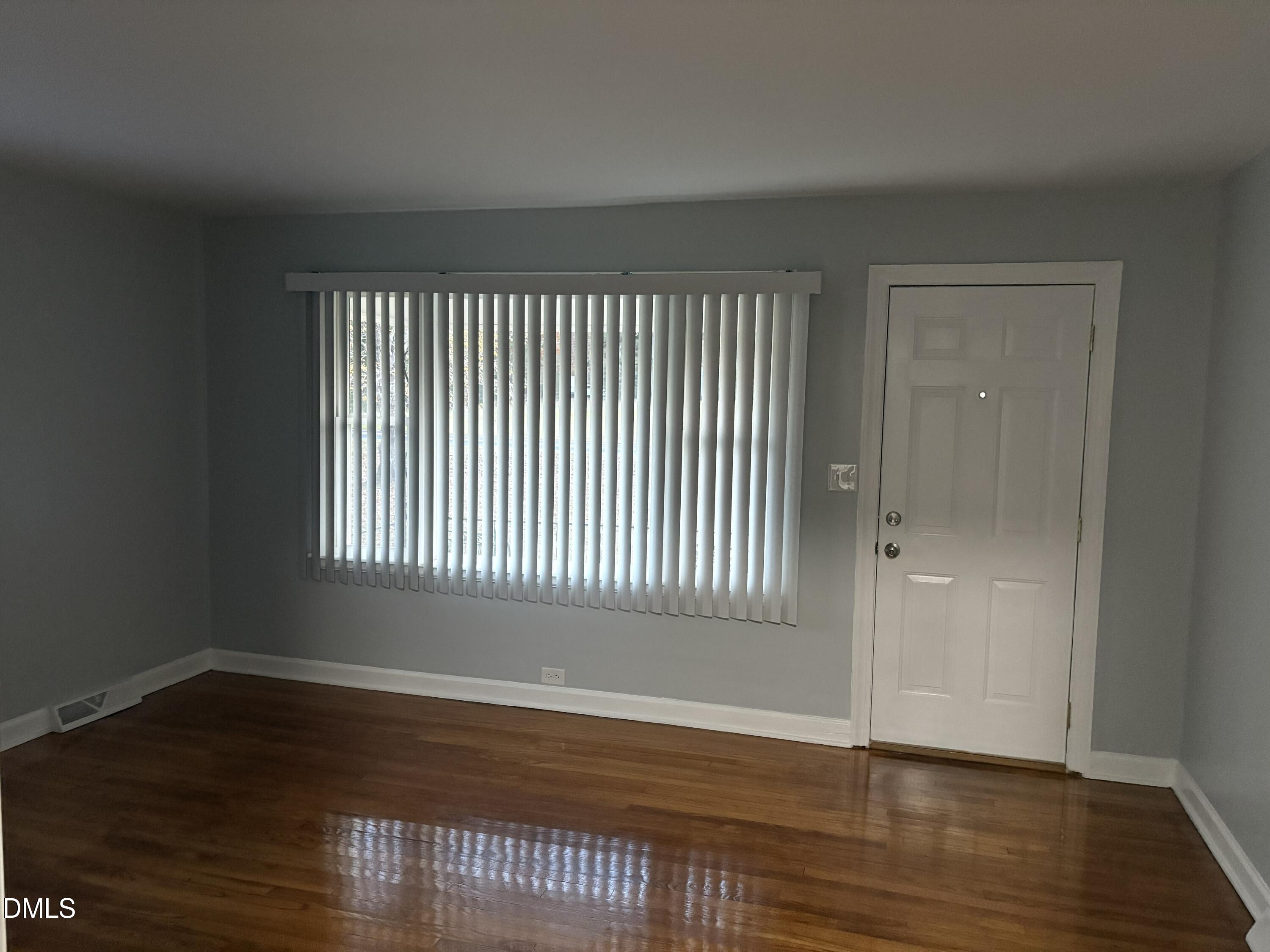 6803 High Rock Road Efland, NC 27243 - Photo 3 of 11 an empty room with wooden floor and windows