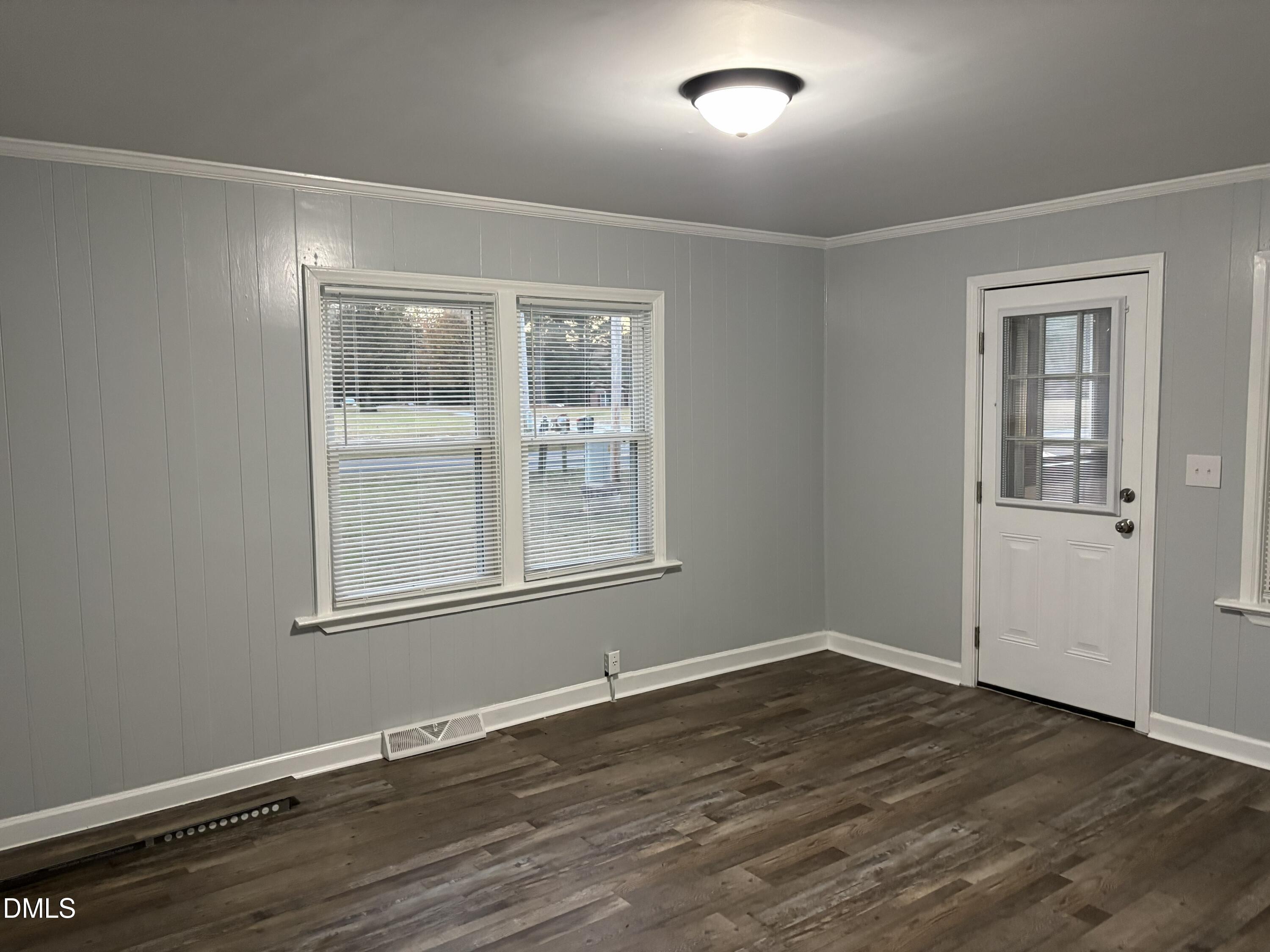 6803 High Rock Road Efland, NC 27243 - Photo 4 of 11 an empty room with wooden floor and windows