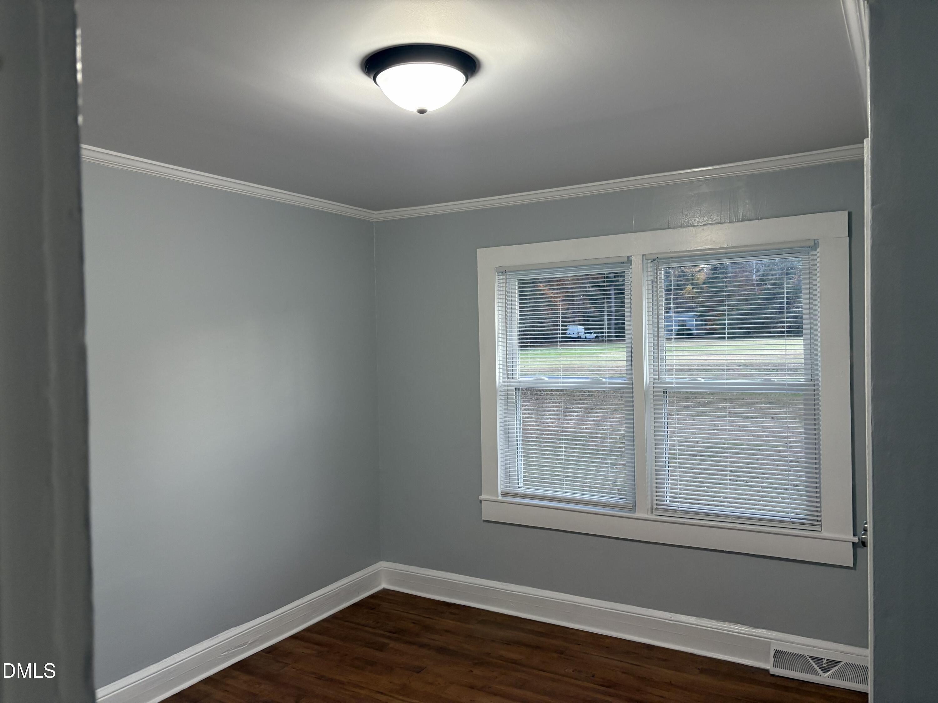 6803 High Rock Road Efland, NC 27243 - Photo 5 of 11 an empty room with wooden floor and windows