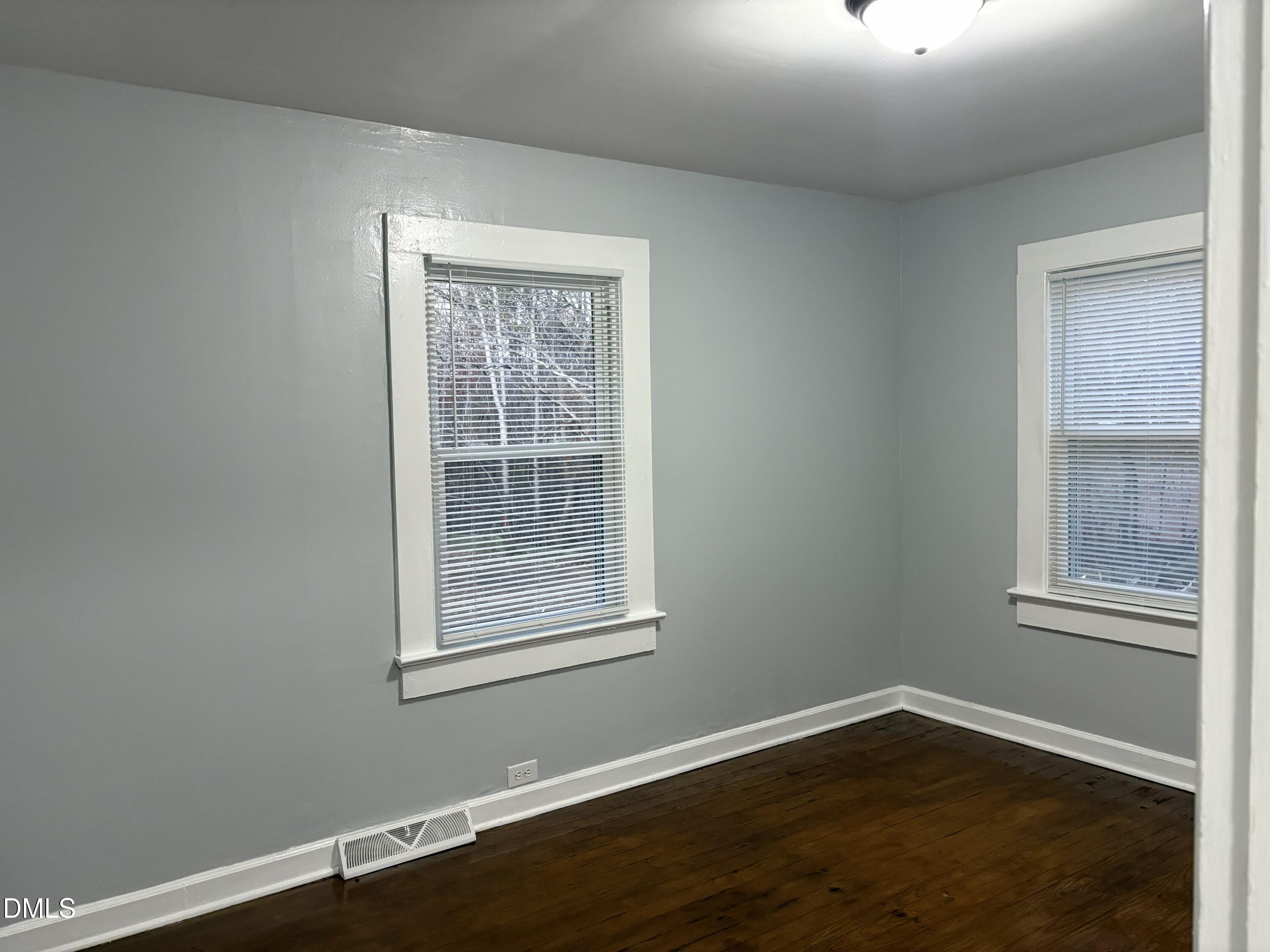 6803 High Rock Road Efland, NC 27243 - Photo 7 of 11 an empty room with wooden floor and windows