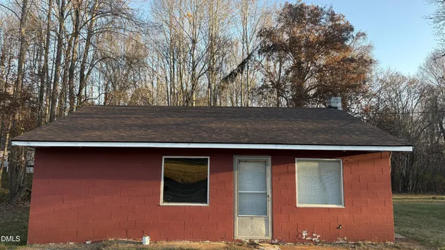 a view of backyard of house with large trees