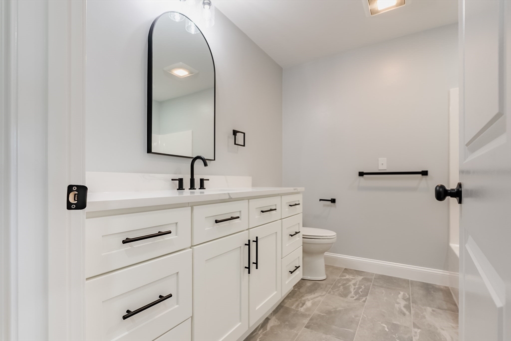 219 Earle Street, Unit 3 Fall River, MA 02723 - Photo 11 of 27 a bathroom with a toilet sink and mirror