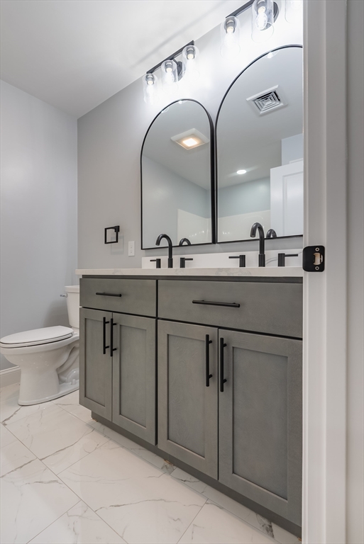219 Earle Street, Unit 3 Fall River, MA 02723 - Photo 18 of 27 a bathroom with a double vanity sink and a toilet