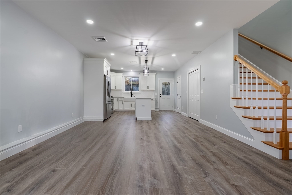 219 Earle Street, Unit 3 Fall River, MA 02723 - Photo 5 of 27 a view of a big room with wooden floor and windows