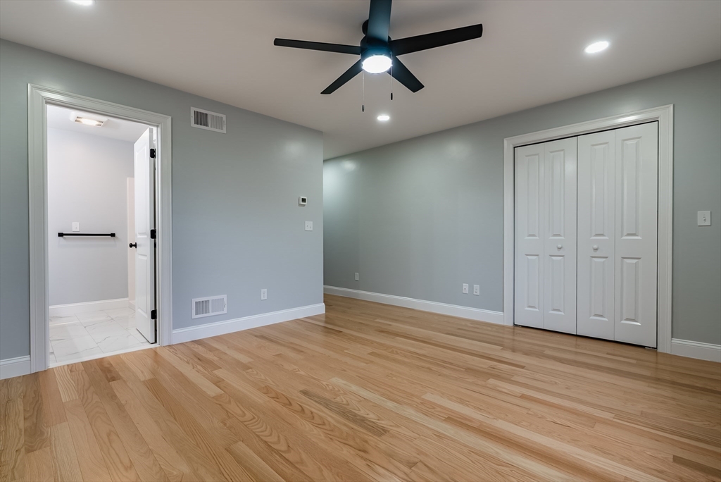 219 Earle Street, Unit 3 Fall River, MA 02723 - Photo 10 of 27 an empty room with wooden floor and a ceiling fan