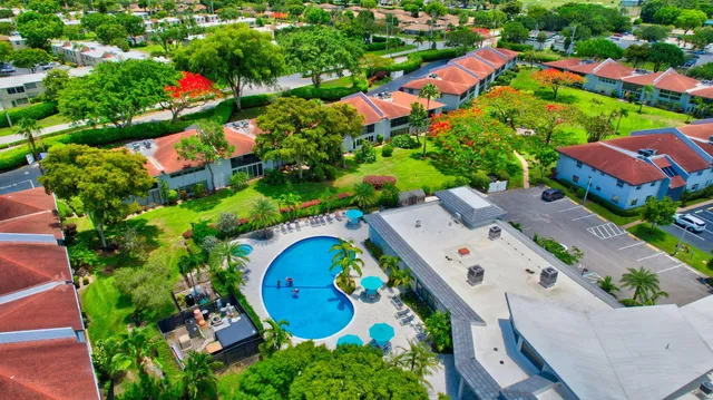 a living room with furniture kitchen and a chandelier