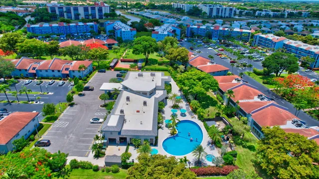 a living room with furniture a table and a large window