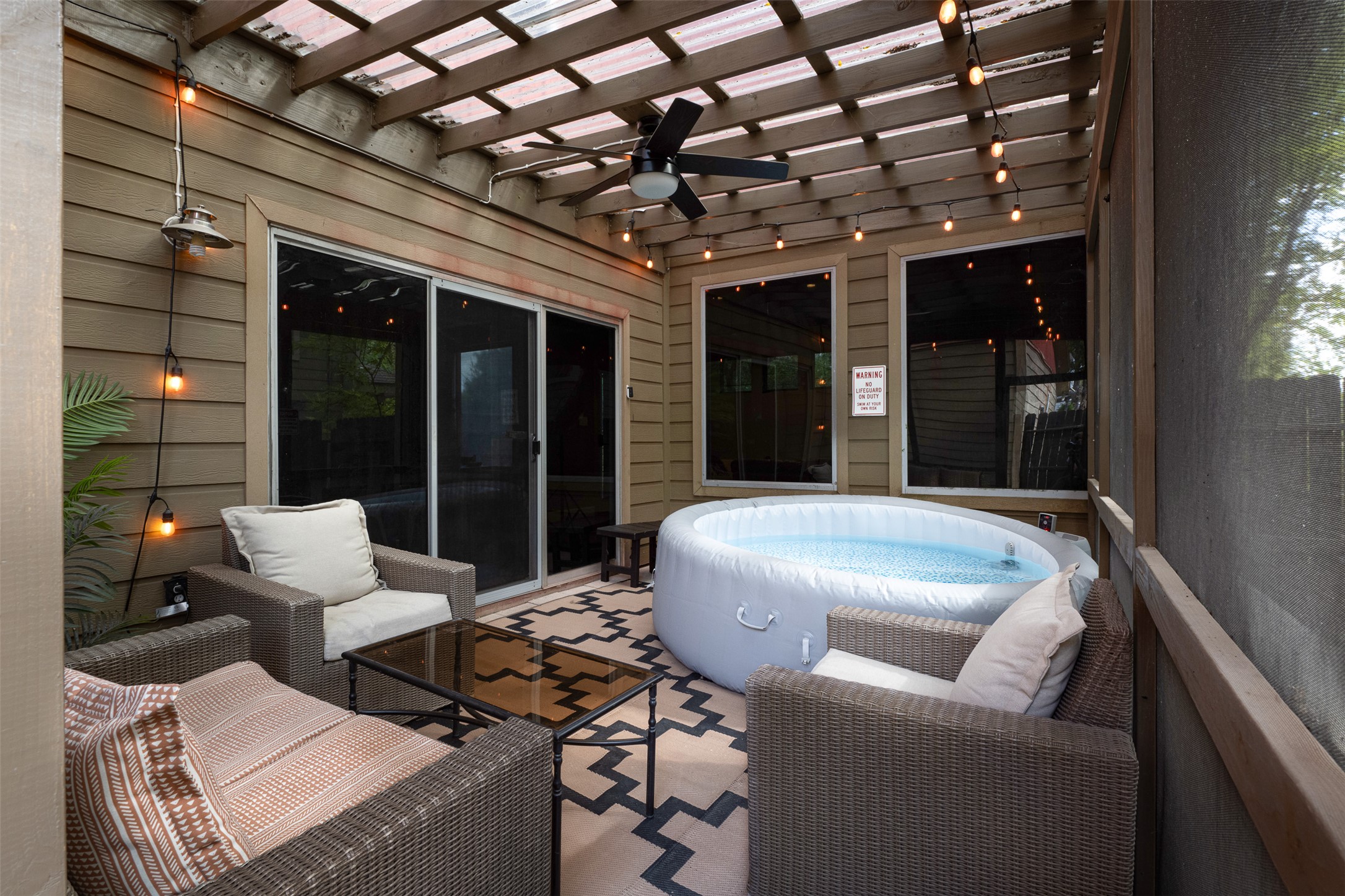 2302 East 9th Street Austin, TX 78702 - Photo 29 of 31 Unwind in this screened porch with a soothing spa, ideal for tranquil evenings.