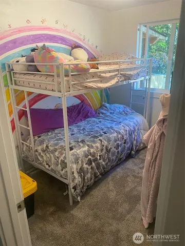 a bed sitting in a room next to a window