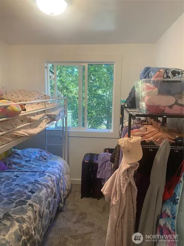 a bedroom with a bed and window