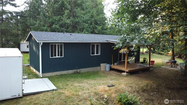 a backyard of a house with table and chairs