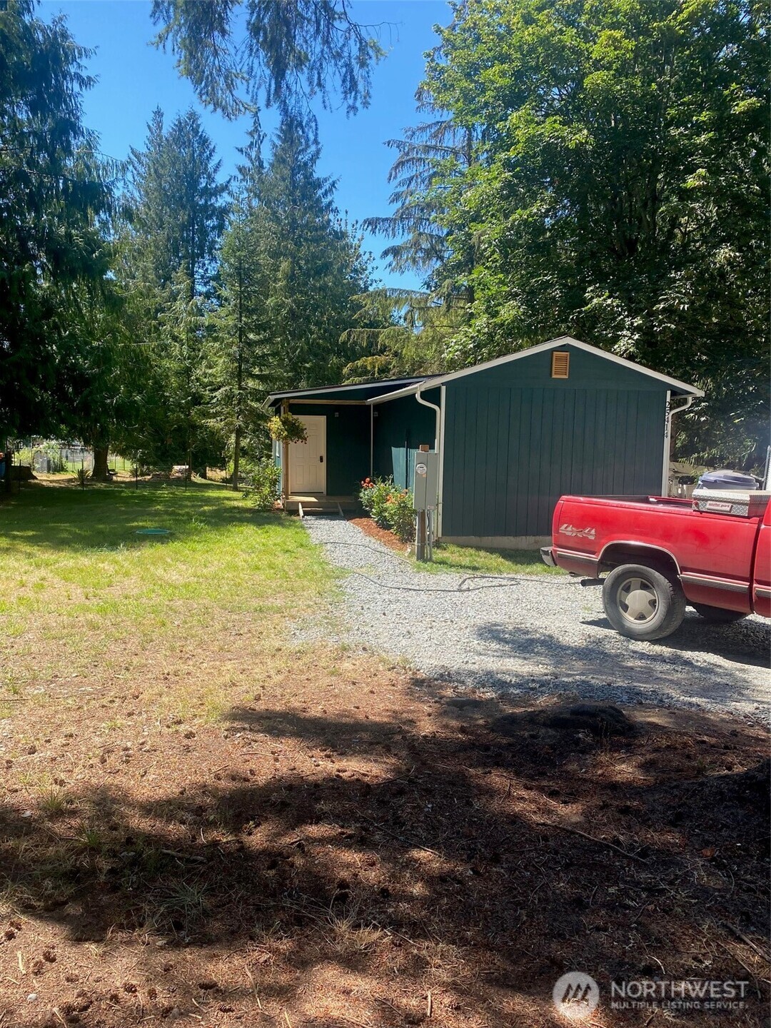 25414 162nd Street East Buckley, WA 98321 - Photo 5 of 17 a car parked in front of a house with large trees