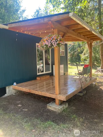 a view of a patio with a table and chairs under an umbrella