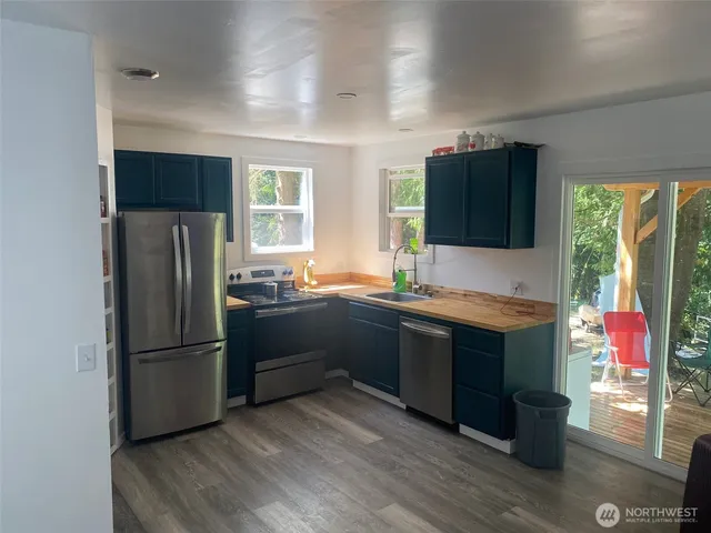a kitchen with stainless steel appliances granite countertop a refrigerator and a sink