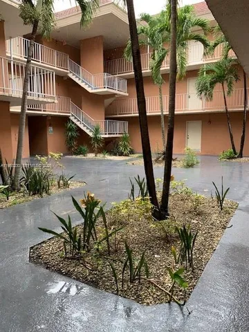 a view of backyard with outdoor seating and plants