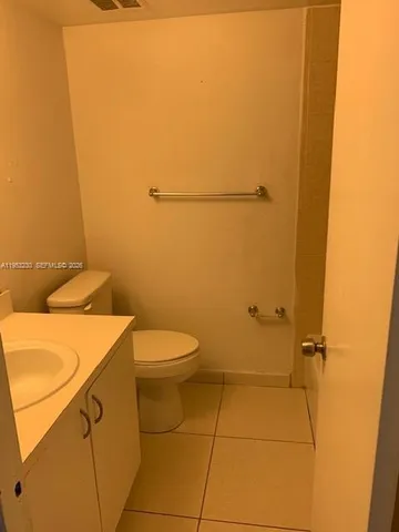 a bathroom with a toilet sink and vanity