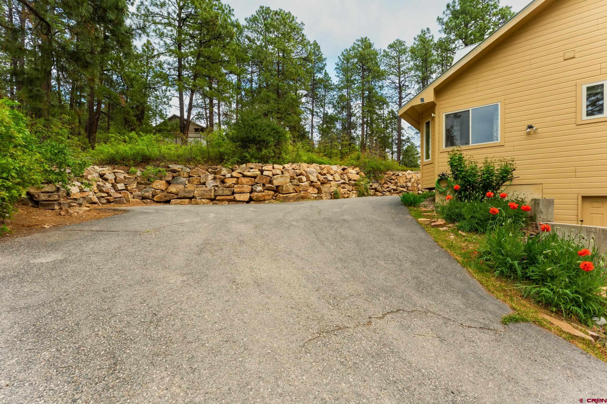 197 Buckhorn Road Bayfield, CO 81122 - Photo 29 of 34 a view of a backyard with potted plants and a large tree
