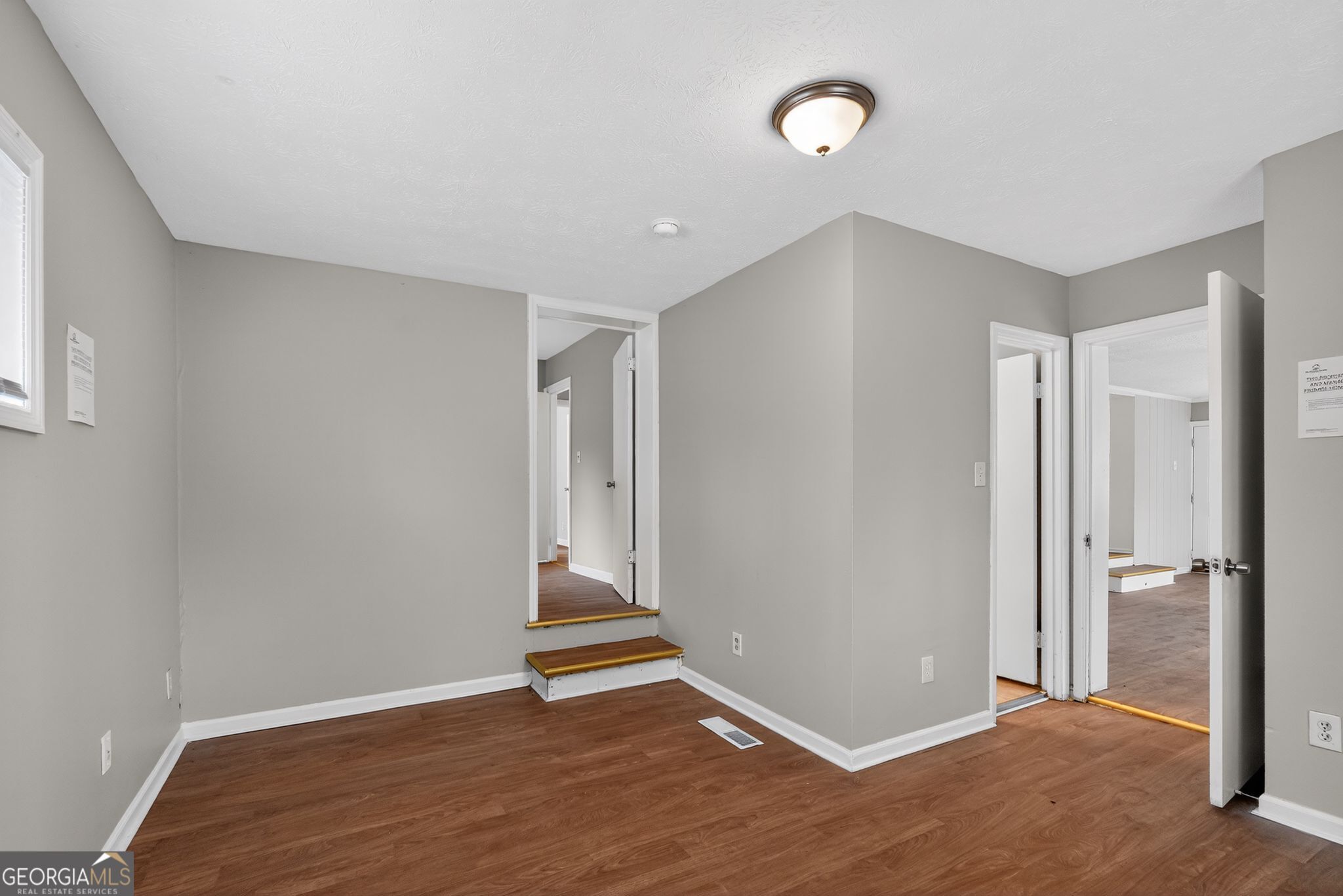 1883 Clarke Lane Decatur, GA 30035 - Photo 12 of 32 an empty room with wooden floor and a ceiling fan
