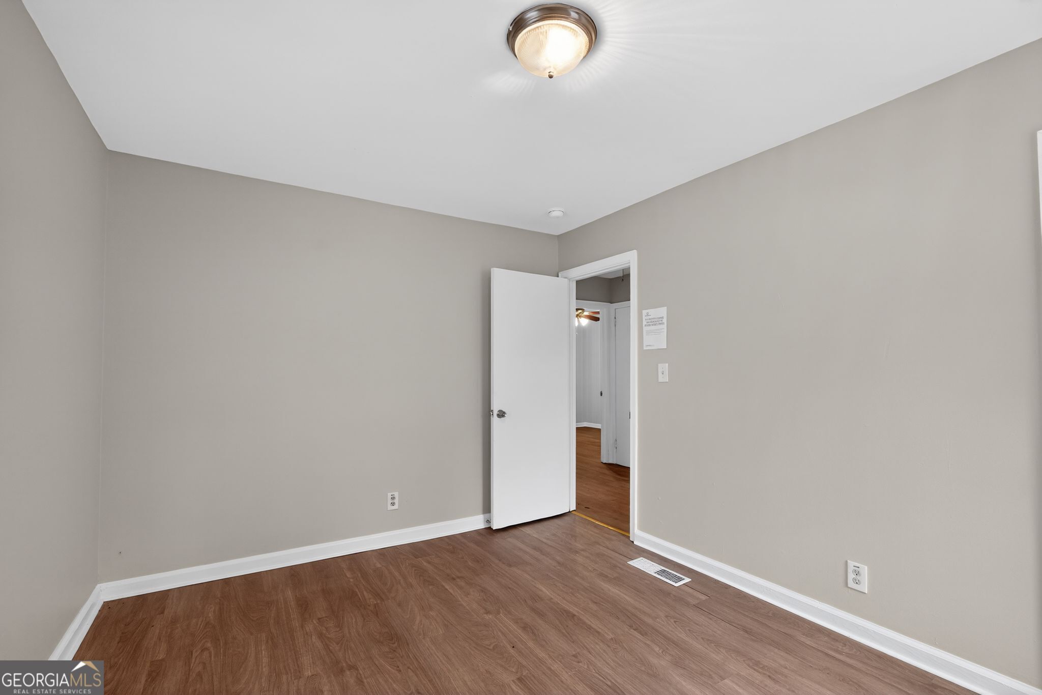 1883 Clarke Lane Decatur, GA 30035 - Photo 13 of 32 a view of an empty room with wooden floor