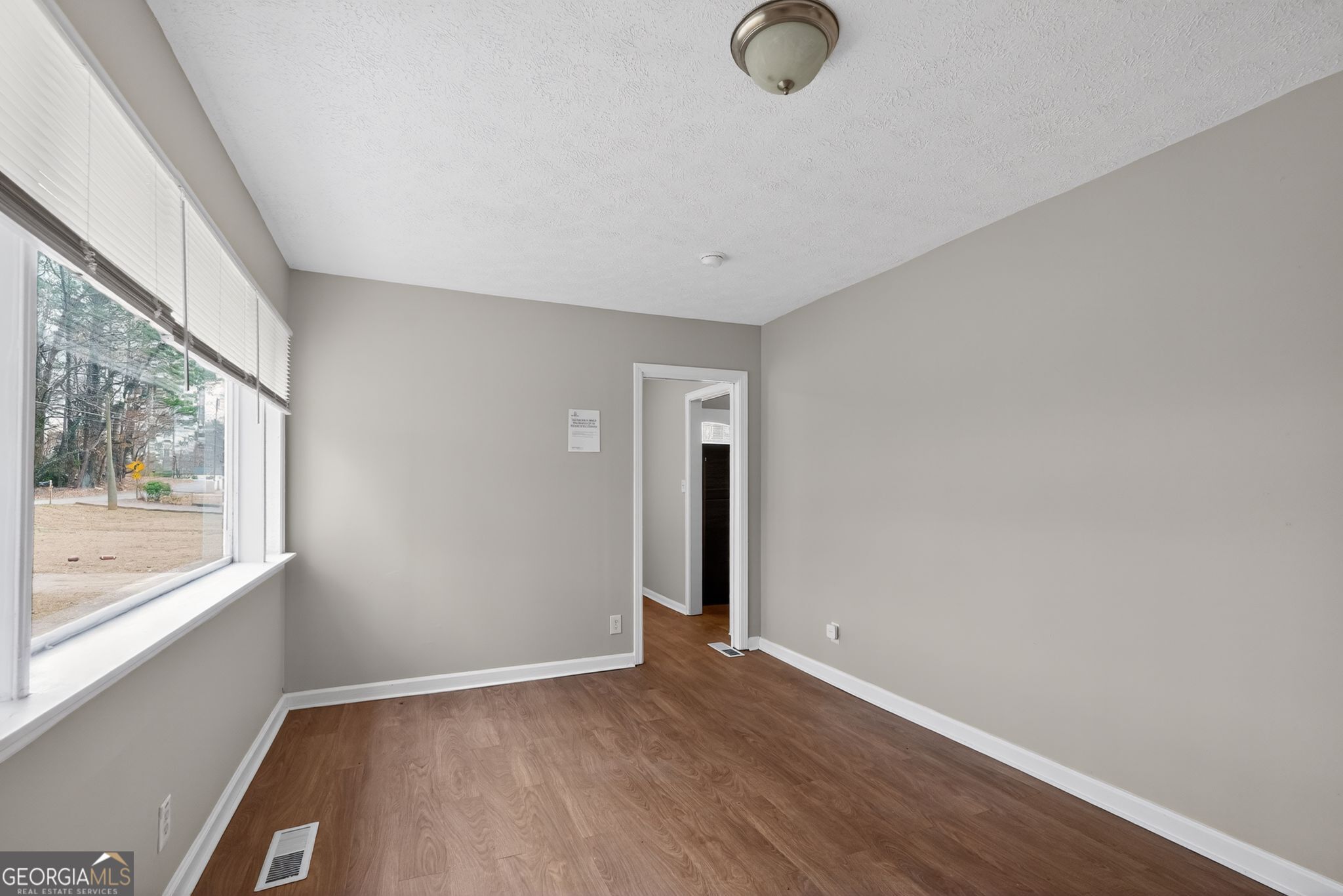 1883 Clarke Lane Decatur, GA 30035 - Photo 15 of 32 an empty room with wooden floor and windows