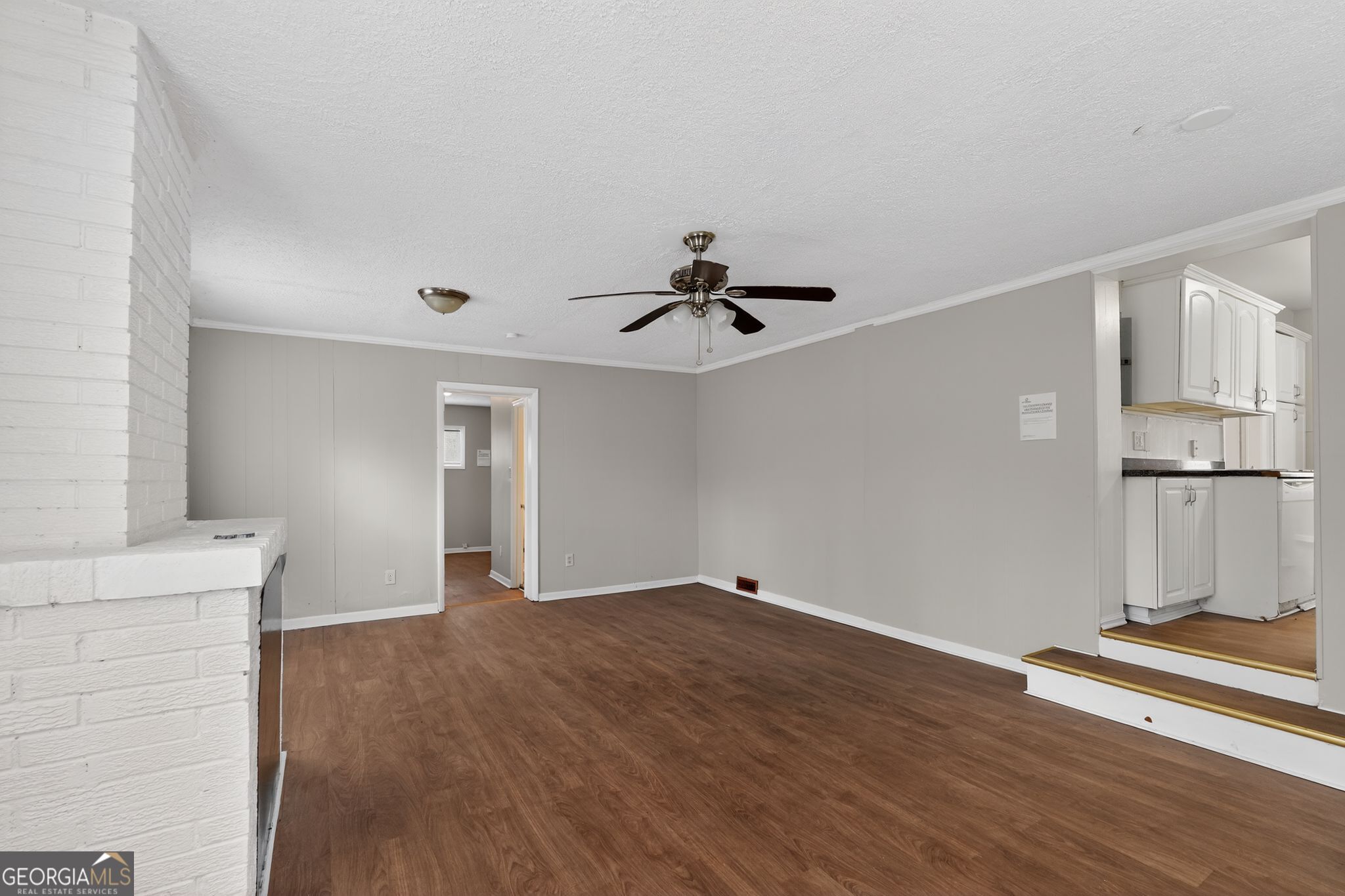 1883 Clarke Lane Decatur, GA 30035 - Photo 17 of 32 a view of an empty room with wooden floor and a ceiling fan