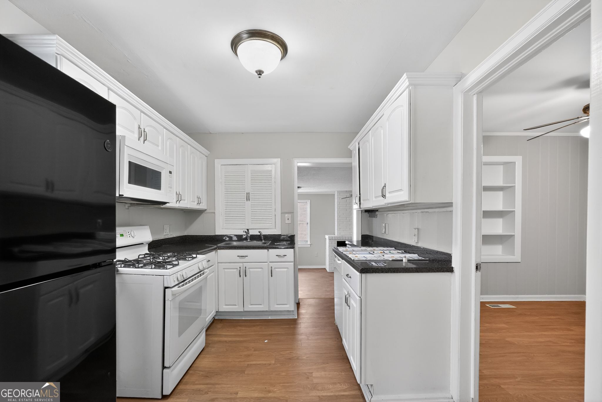 1883 Clarke Lane Decatur, GA 30035 - Photo 20 of 32 a kitchen with granite countertop a sink stainless steel appliances and cabinets