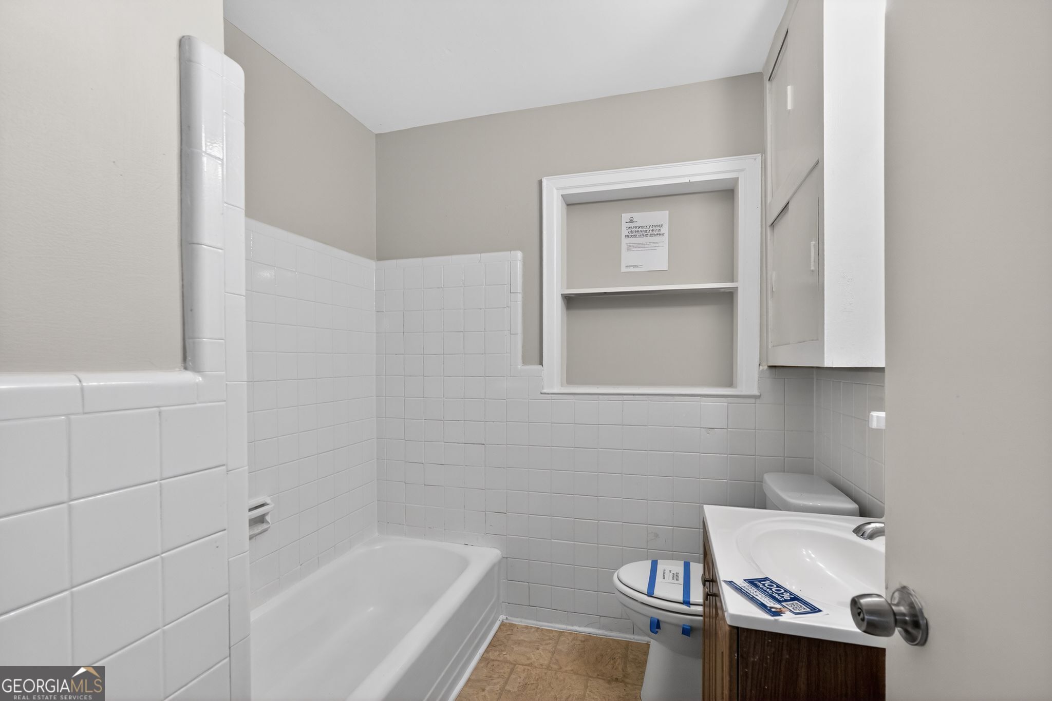 1883 Clarke Lane Decatur, GA 30035 - Photo 29 of 32 a bathroom with a sink a toilet and bathtub