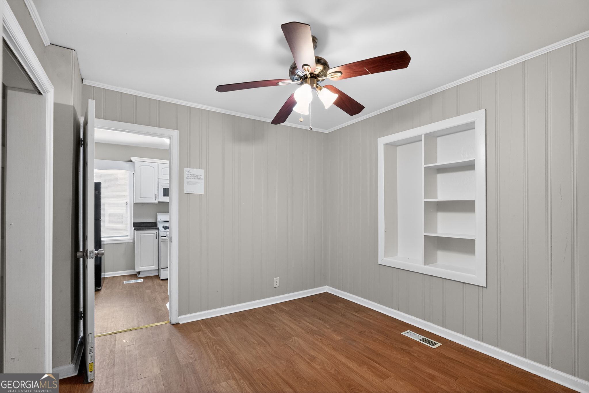 1883 Clarke Lane Decatur, GA 30035 - Photo 5 of 32 a view of an empty room with wooden floor and a window