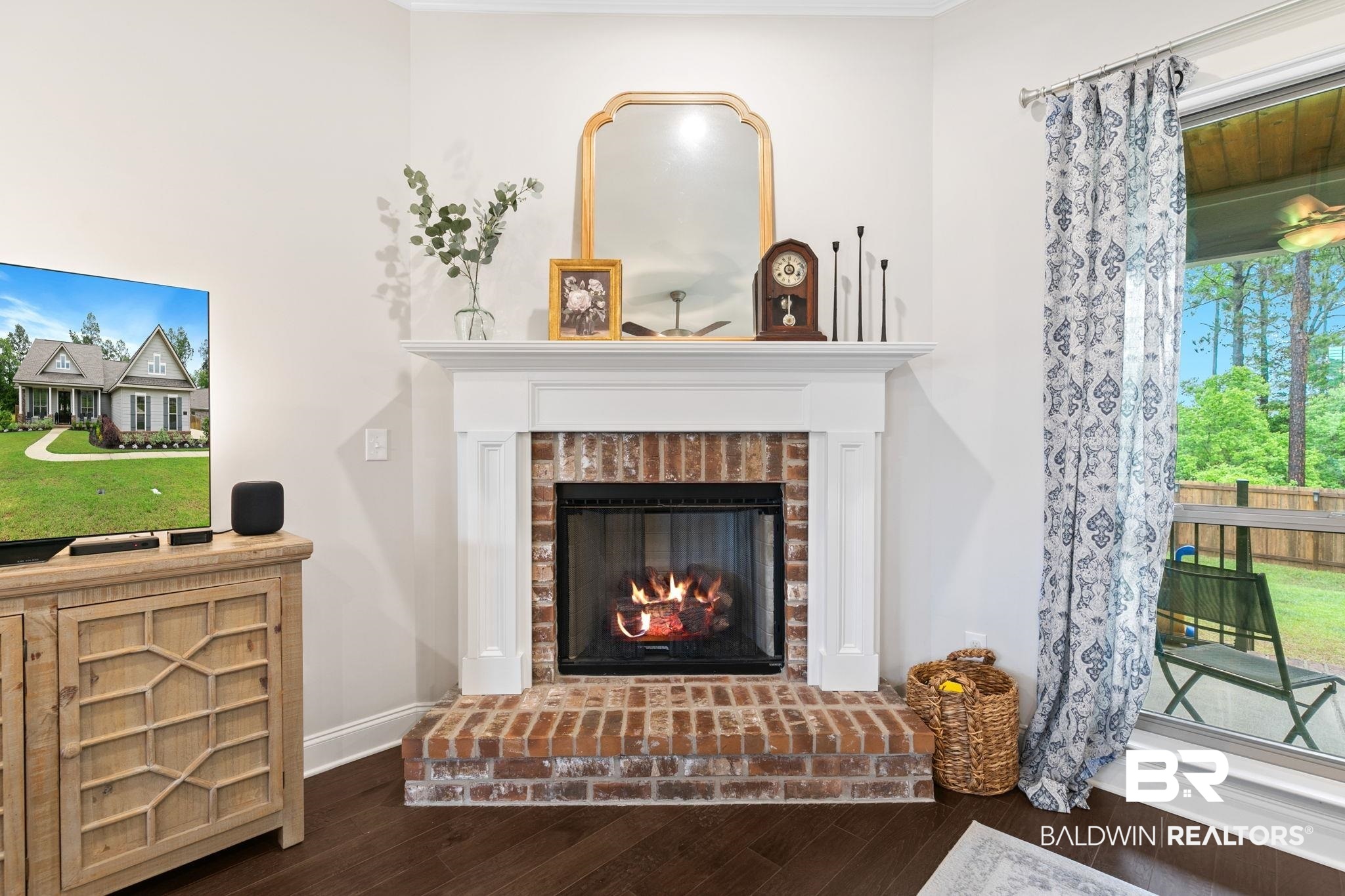 13233 Ibis Boulevard Daphne, AL 36527 - Photo 9 of 100 Brick fireplace with a white mantel and hearth, set against light-toned walls