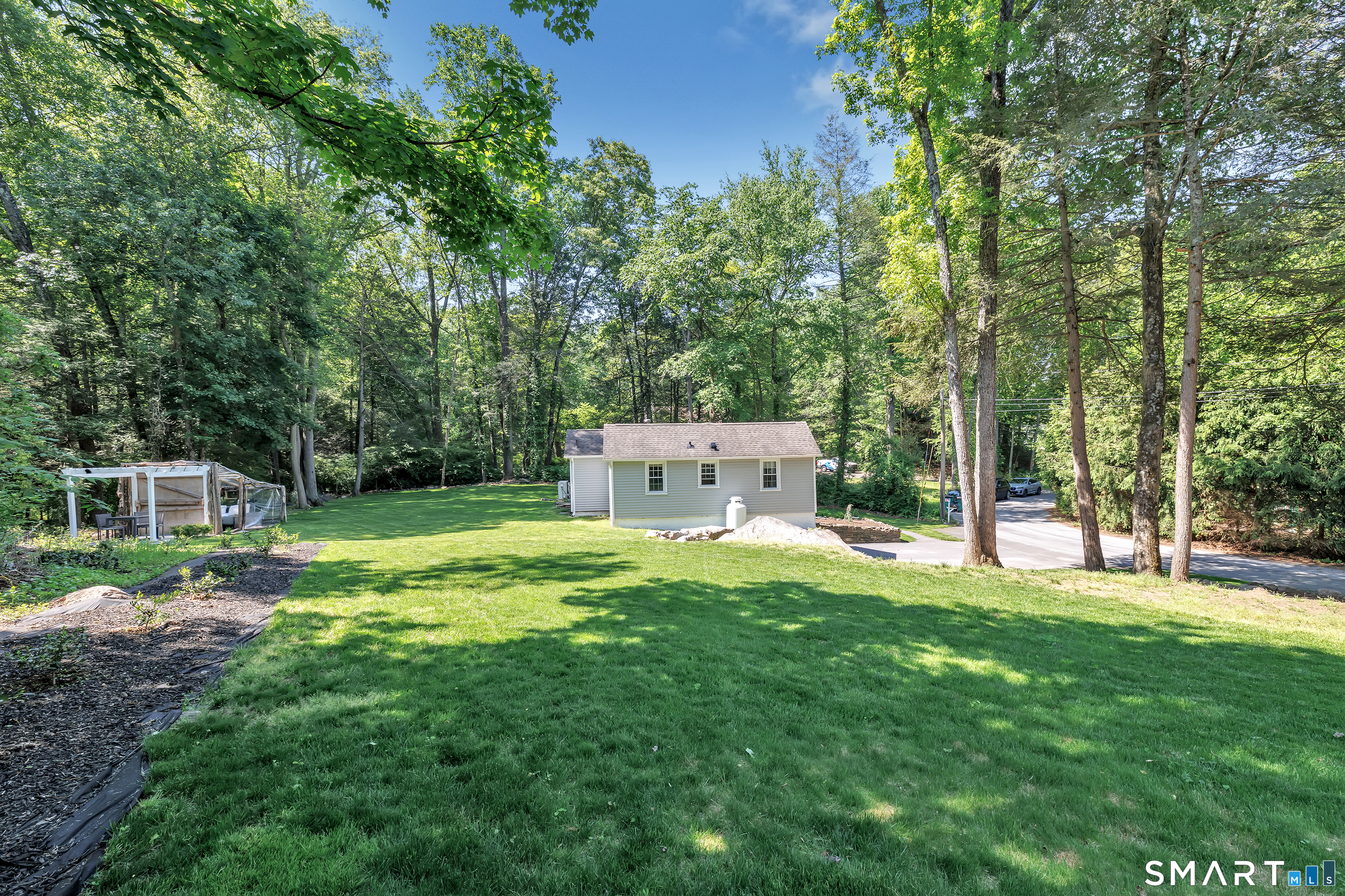57 Olmstead Road Redding, CT 06896 - Photo 19 of 22 a house view with a sitting space and garden