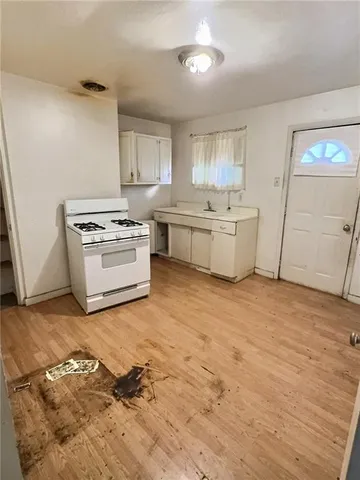 a kitchen with a stove top oven and cabinets