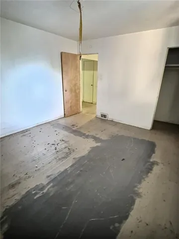a view of a hallway with a refrigerator