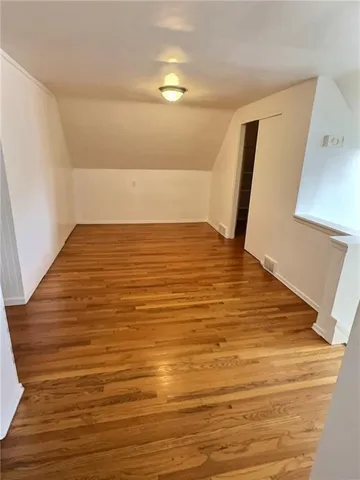 a view of water heater room with wooden floor