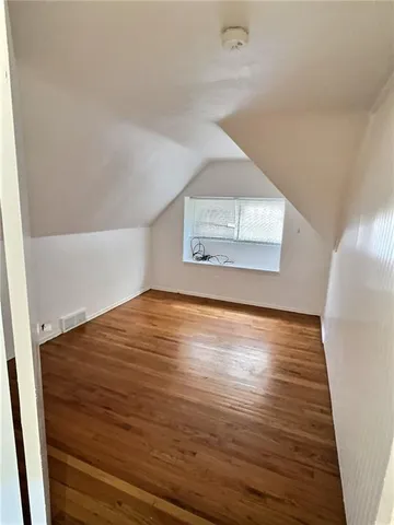 a view of an empty room and wooden floor