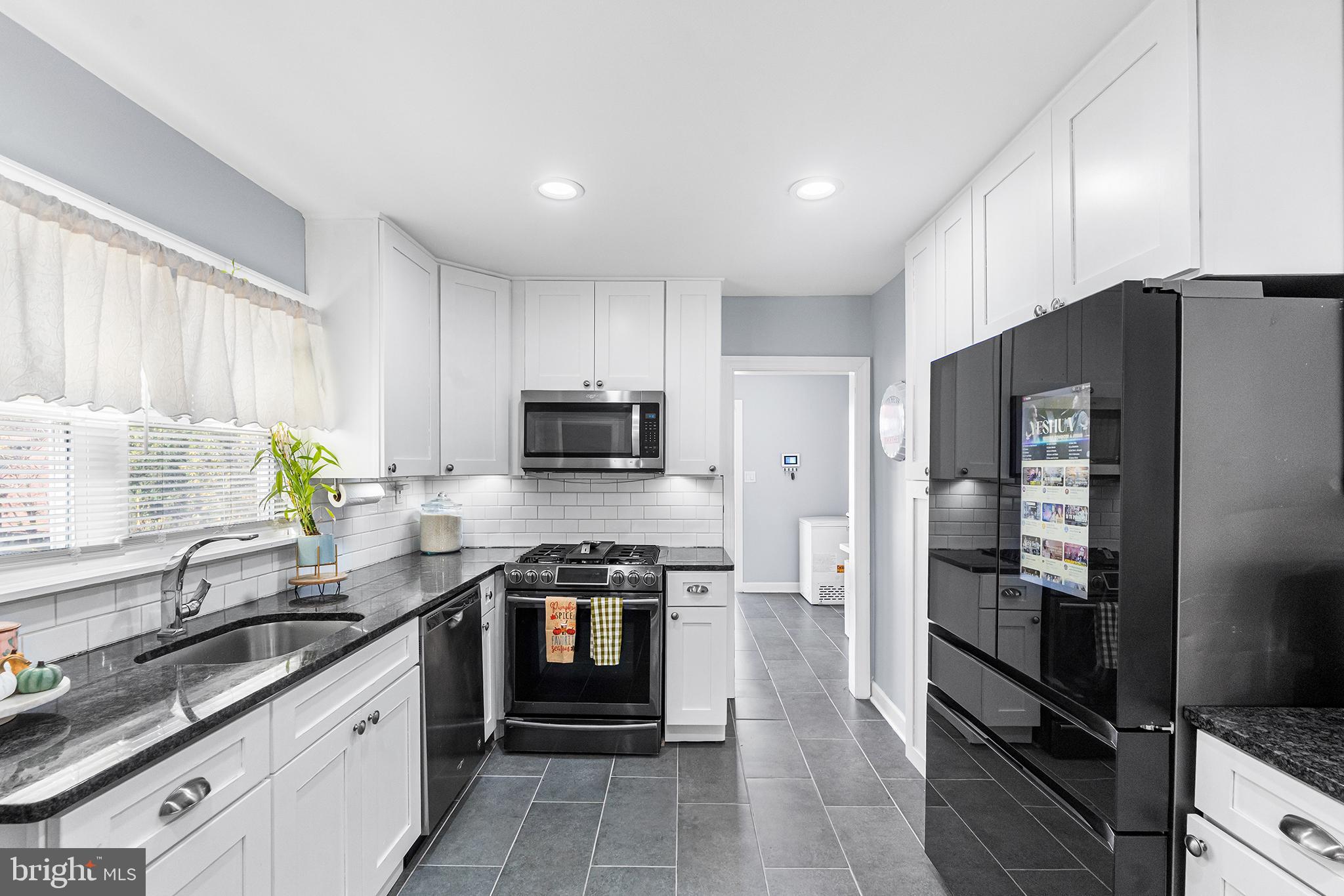 14 Nicholson Road Mount Ephraim, NJ 08059 - Photo 13 of 38 Modern kitchen with sleek black accents.