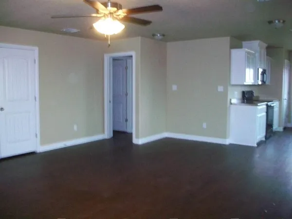 a view of a livingroom with a ceiling fan and window