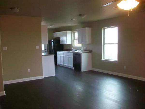 a view of a room with window and wooden floor