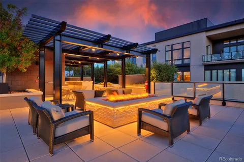 a view of a patio with dining table and chairs with a small yard
