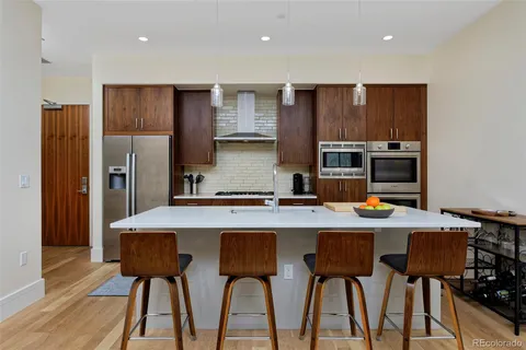 a kitchen with a table chairs refrigerator and microwave