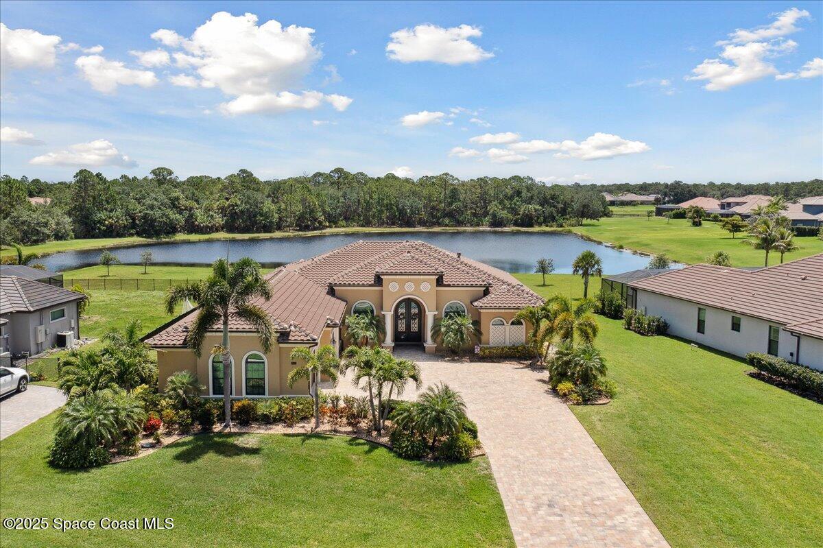 an aerial view of a house with pool lake view and mountain view
