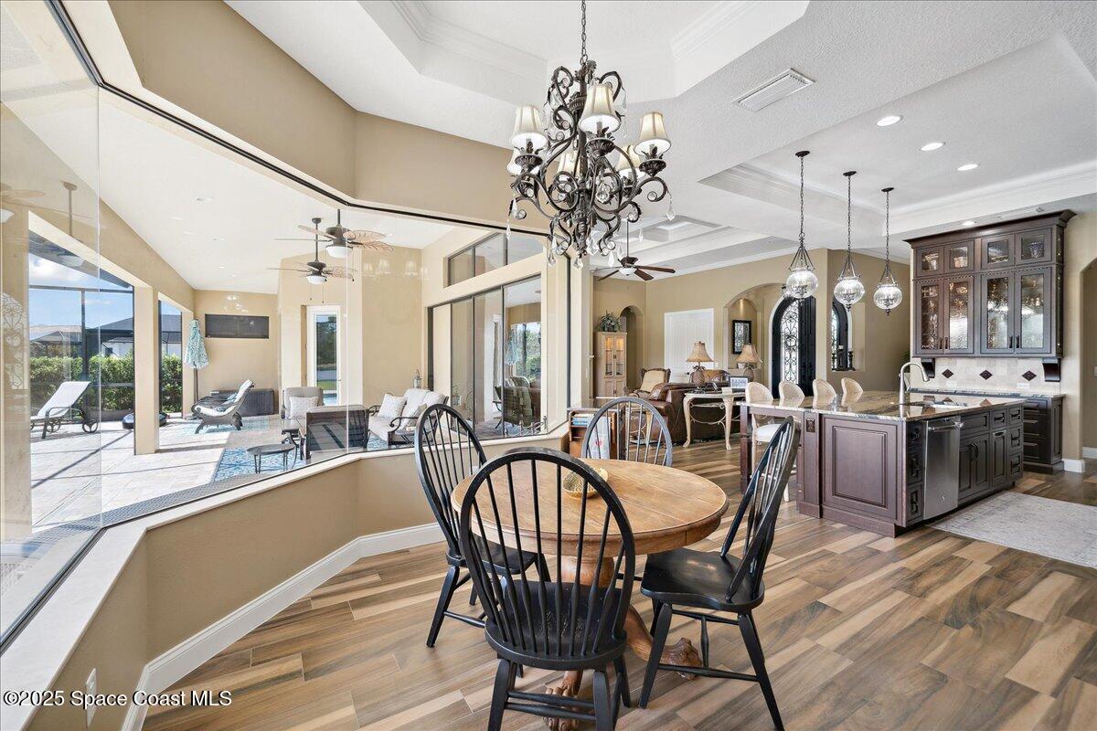 4464 Preservation Circle Melbourne, FL 32934 - Photo 13 of 65 a view of a dining room with furniture window and wooden floor