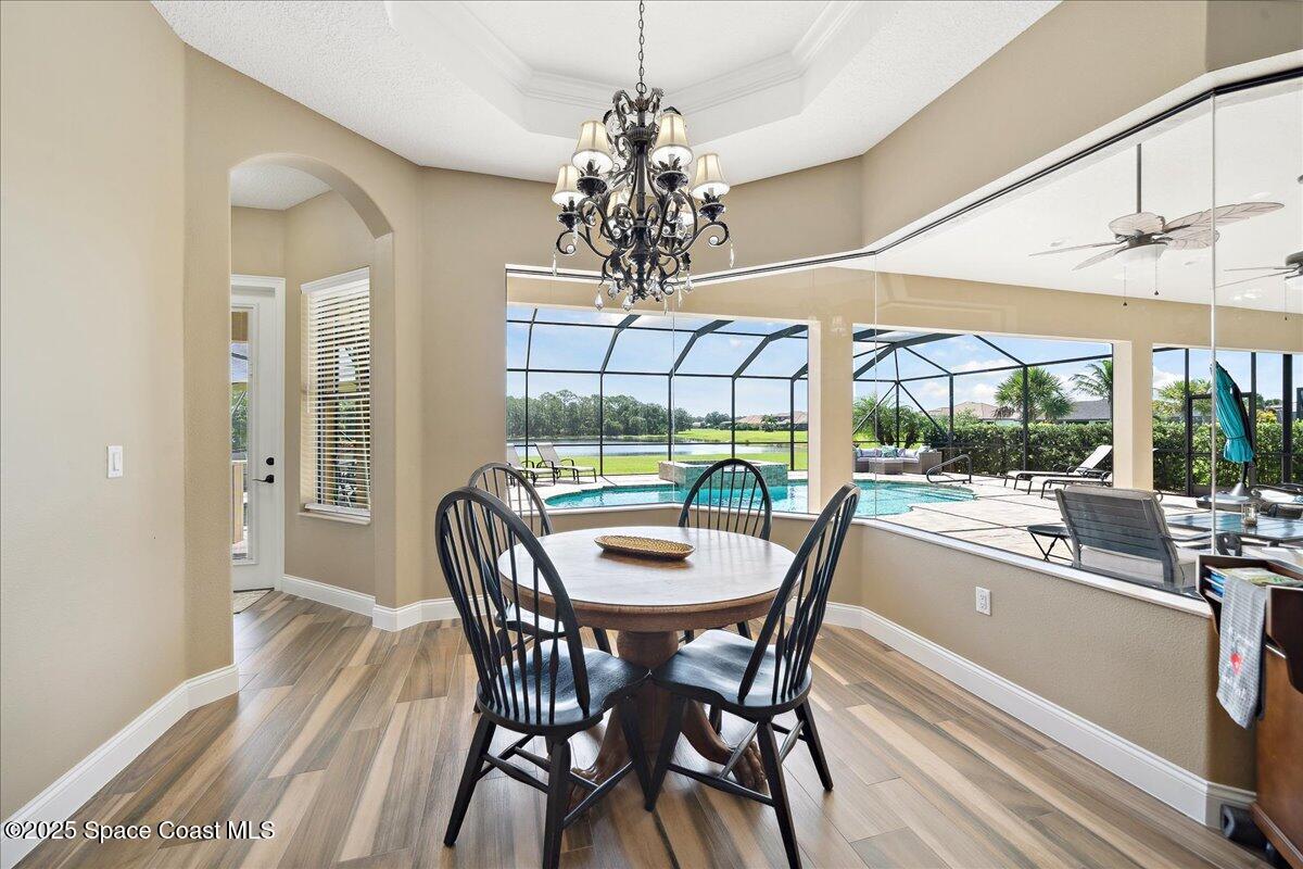 4464 Preservation Circle Melbourne, FL 32934 - Photo 14 of 65 a dining room with furniture a chandelier and window